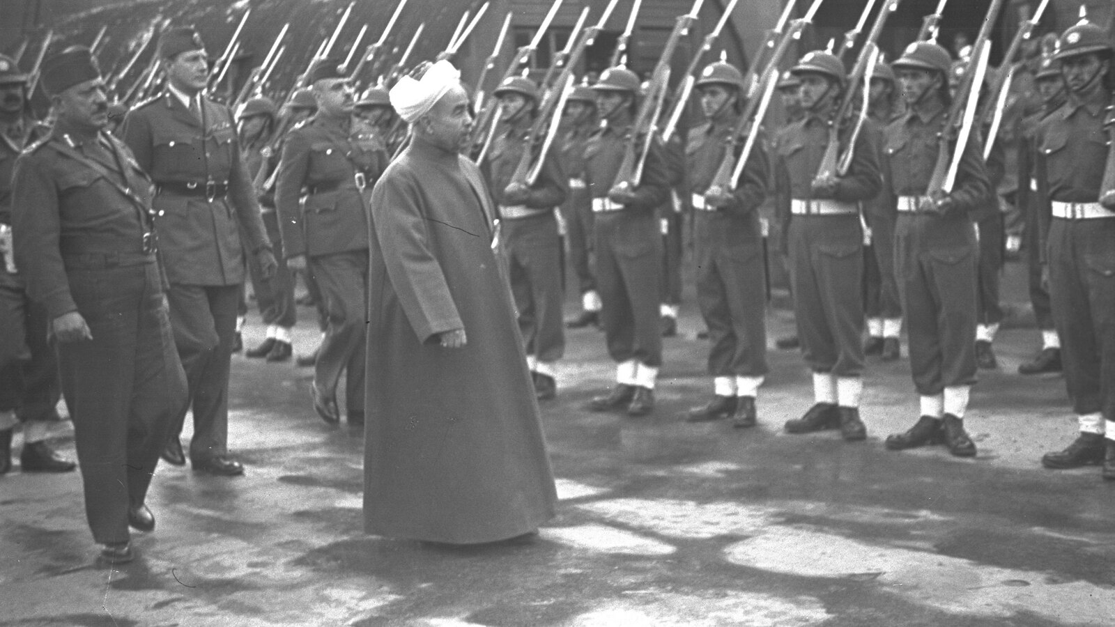 Emir Abdullah of Transjordan inspecting an Arab Legion honor guard at Haifa in 1946.