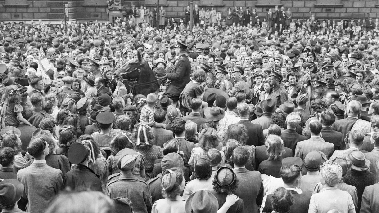Crowds fill Whitehall in London to celebrate Victory in Europe Day, 8 May 1945.