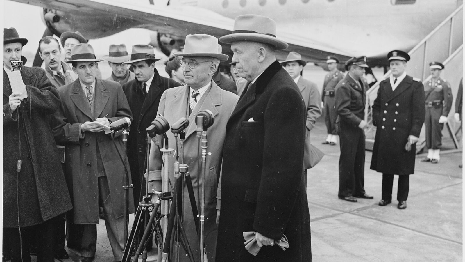 President Truman and Secretary of State George Marshall at microphones at Washington National Airport, November 1947.
