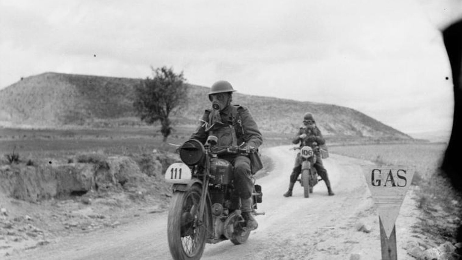 British Army despatch riders in gas masks during a 50-mile motorcycle trial exercise in Cyprus, 3 March 1942