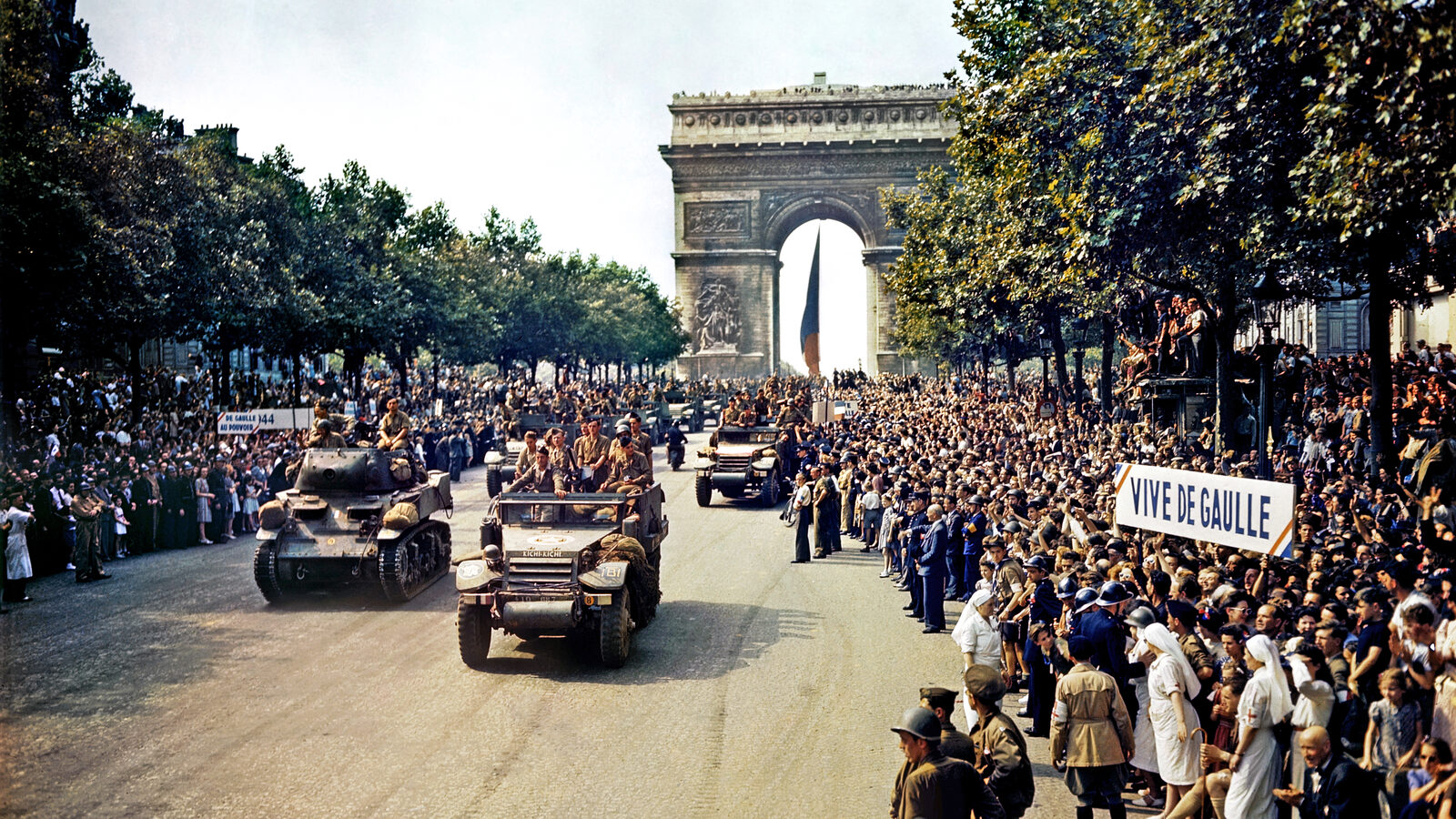 Crowds of French patriots line the Champs-Élysées as Free French armor passes the Arc de Triomphe during the Liberation of Paris, August 26, 1944