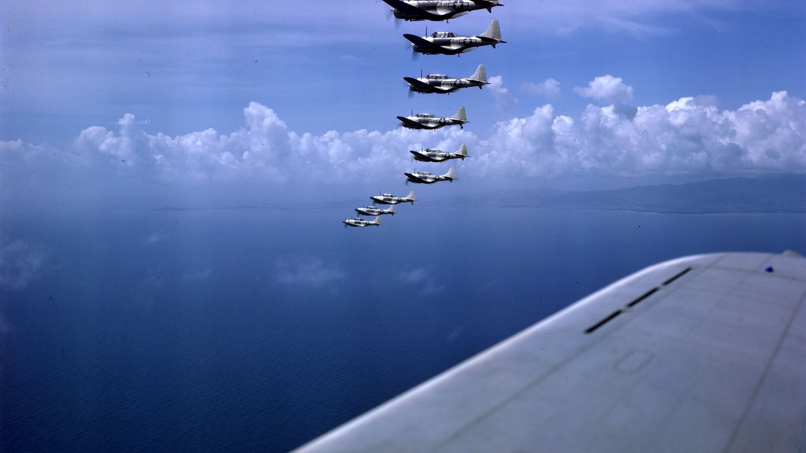 Marine Scouting Squadron VMS-3 "Devilbirds" Douglas SBD-5 Dauntless dive bombers in formation over the Caribbean, circa 1943, flying from MCAS Bourne Field on St. Thomas