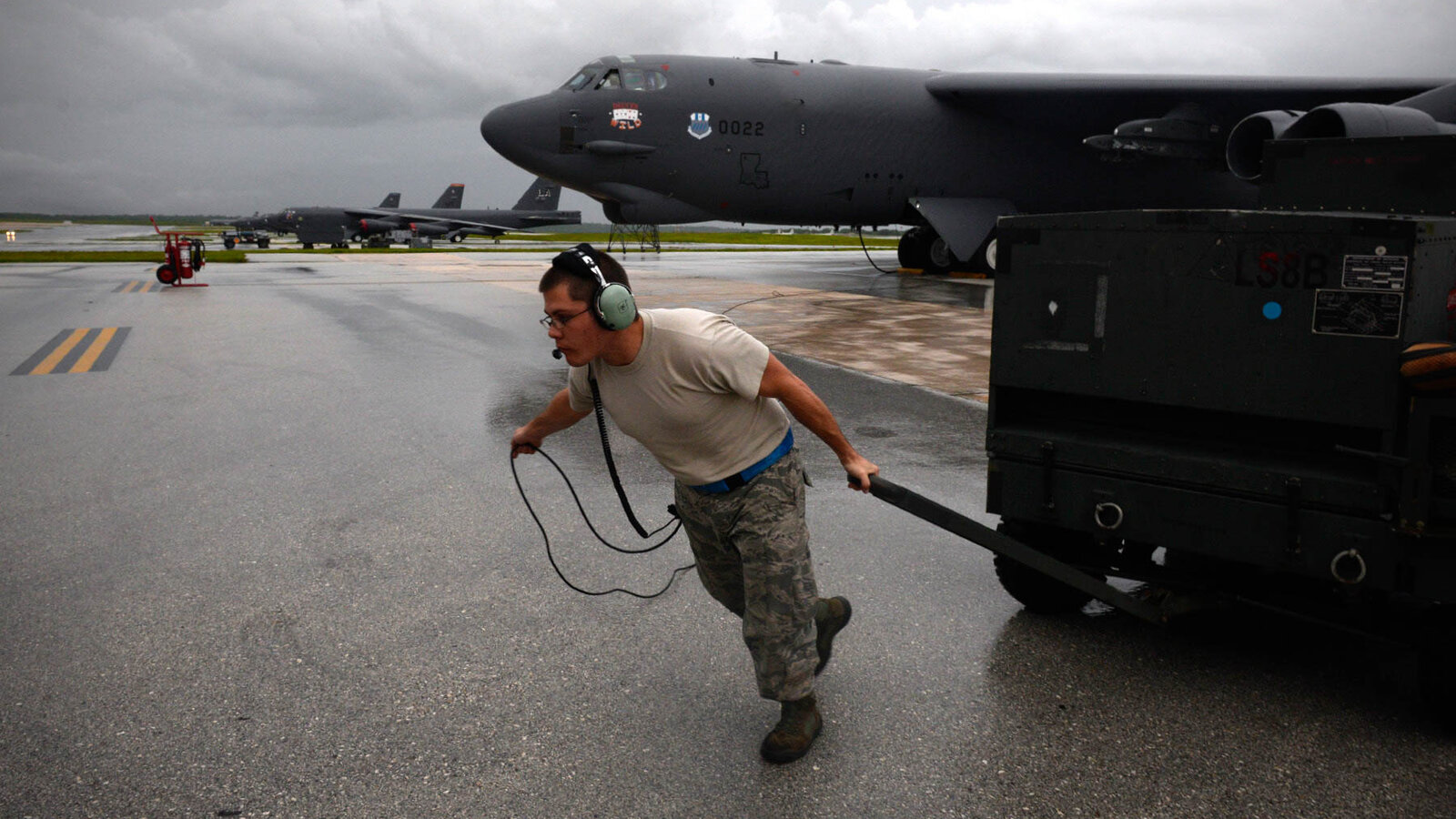 B-52 Stratofortress crew chief moves ground equipment during launch operations at Andersen Air Force Base, Guam, August 2015