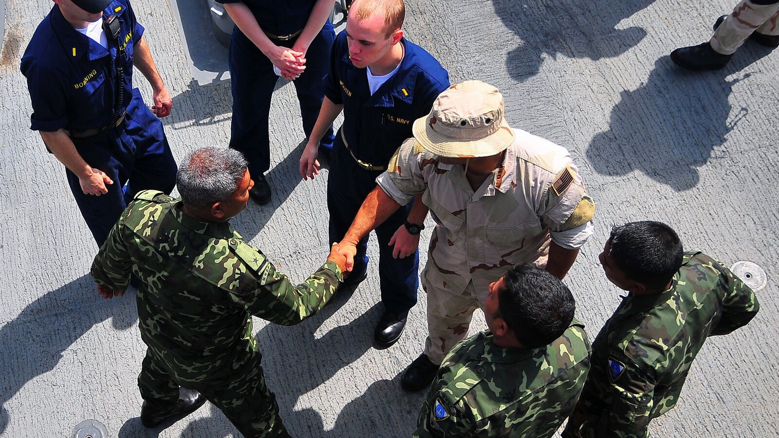 Maldives National Defense Force Coast Guard members meet with the visit, board, search and seizure team aboard USS Lake Champlain, February 2009