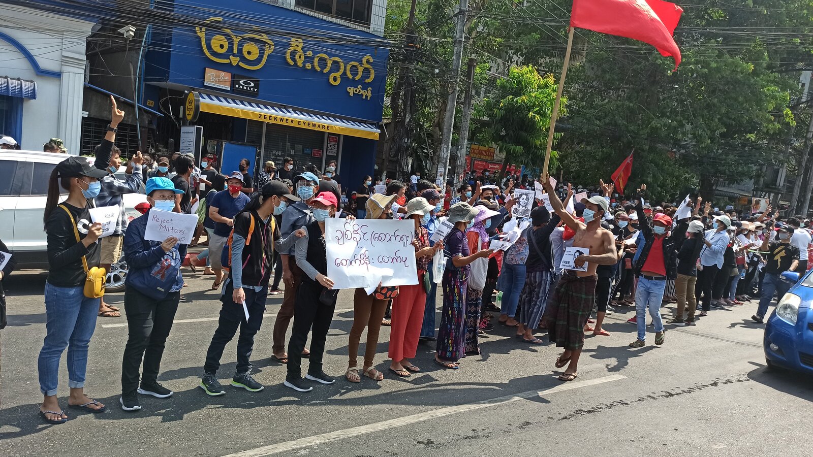NLD supporters protest the 1 February 2021 coup d'état near the University of Yangon, Myanmar, February 8, 2021
