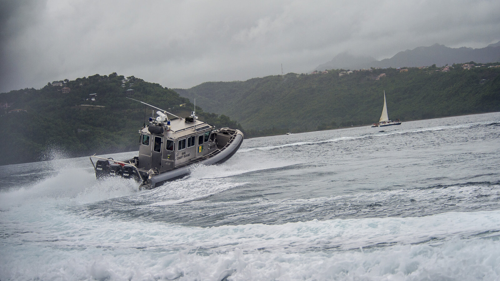 A St. Vincent and the Grenadines coast guard interceptor performs a corkscrew maneuver in St. Lucia during TRADEWINDS 2013 boat pursuit drills, May 2013